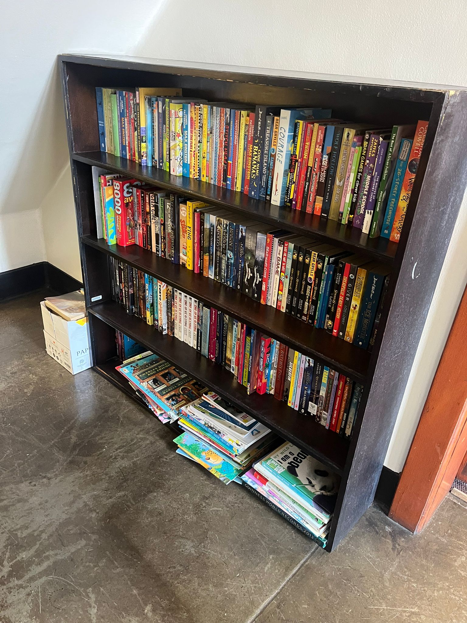 Books donated by St John's College arranged on a bookshelf